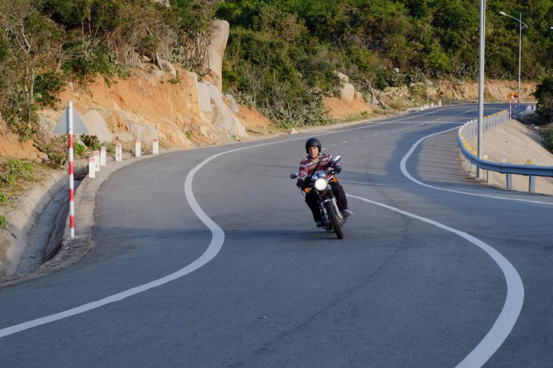 Steve Paris riding his motorbike around a pass